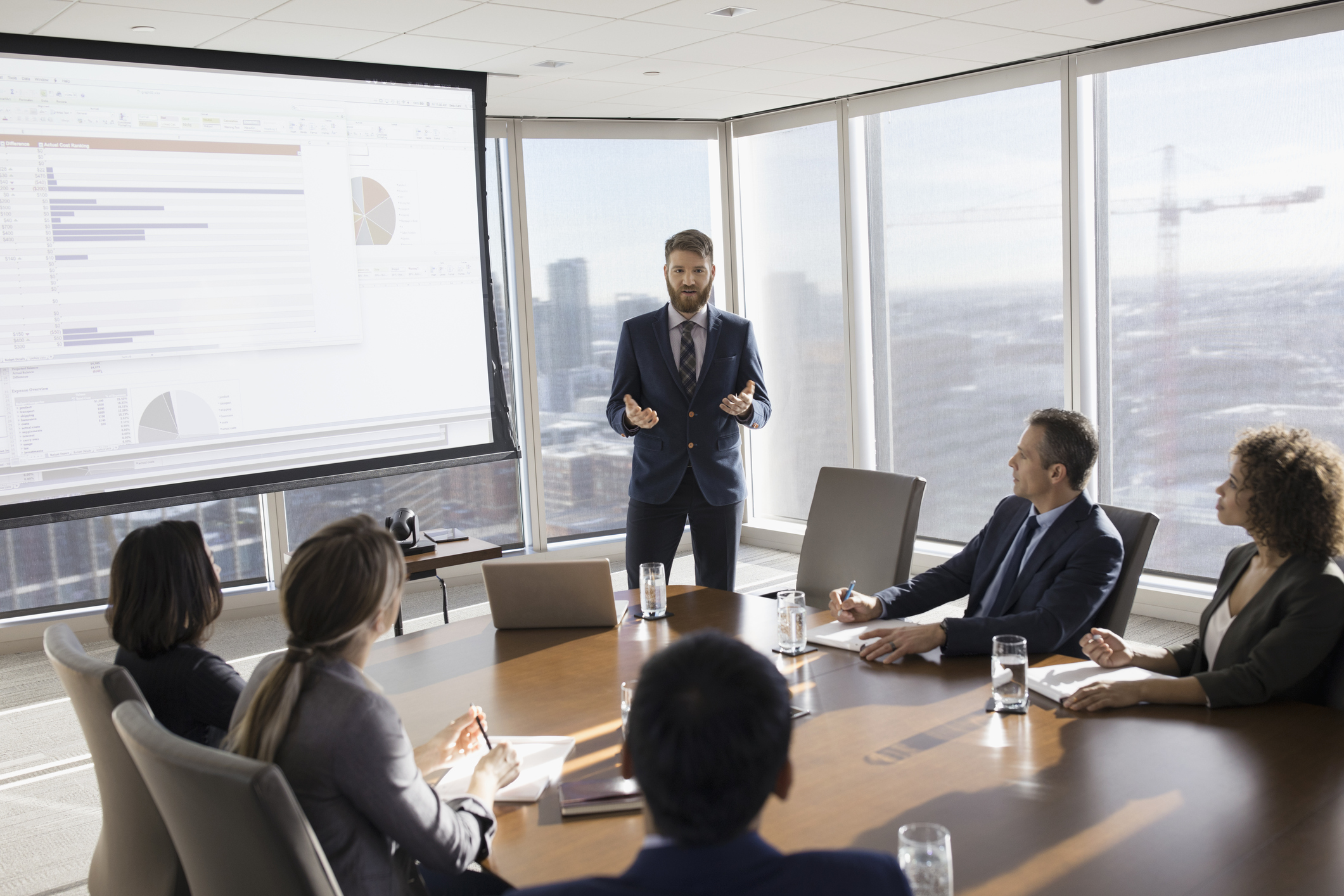 group of businessmen in board room discussing details of setting up a financial business trust